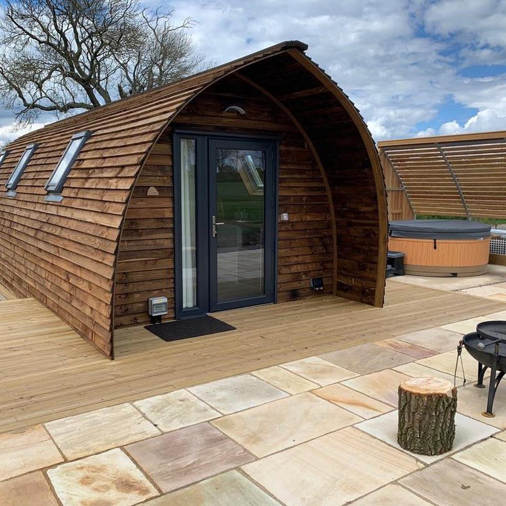 Dog-friendly lodge with a hot tub on the decking at Wigwam Holidays Sedgewell Barn near Northallerton in North Yorkshire